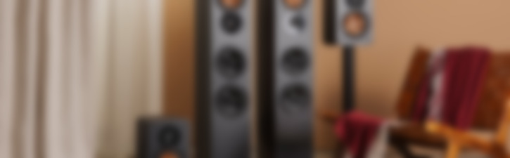 A modern audio setup featuring Ultima 40 Surround speakers in varying sizes.